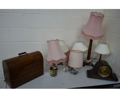AN OAK CASED SINGER SEWING MACHINE together with an oak mantel clock, oak standard lamp with a slopped stepped base, a pair o