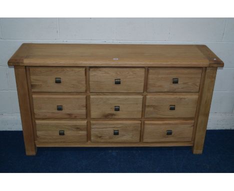 A MODERN LIGHT OAK SIDEBOARD with nine drawers, width 151cm x depth 40cm x height 82cm (was in original packaging prior to ph