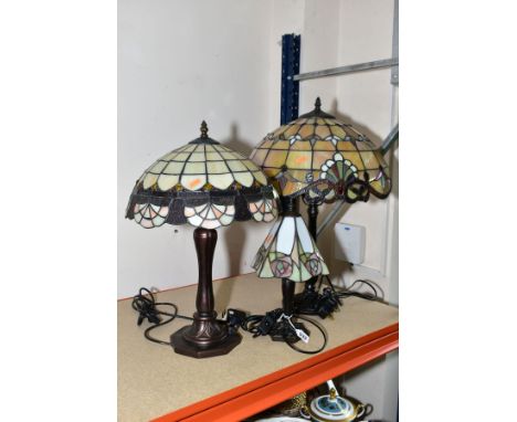 THREE TABLE LAMPS having glass Tiffany style shades, heights 35cm, 47cm and 53cm, all measurements include the finial