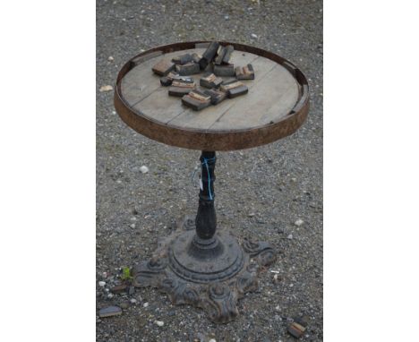 A VICTORIAN CAST IRON PUB TABLE with a footed circular base with foliate detail and a single cylindrical stem height 72cm and