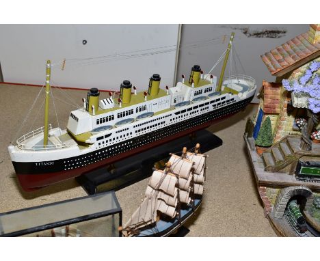 A MODEL OF TITANIC, length 53cm x height 23cm, including stand with a resin cuckoo type mantle clock featuring The Flying Sco