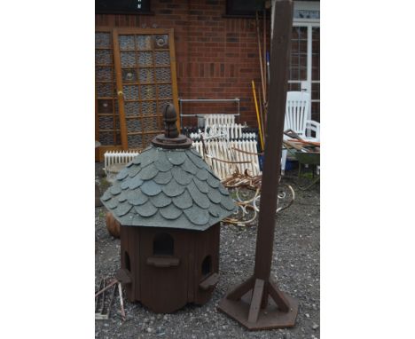 A STAINED WOOD HEXAGONAL DOVECOTE on a square pillar support and base, diameter 86cm x overall height 306cm x height of top 1