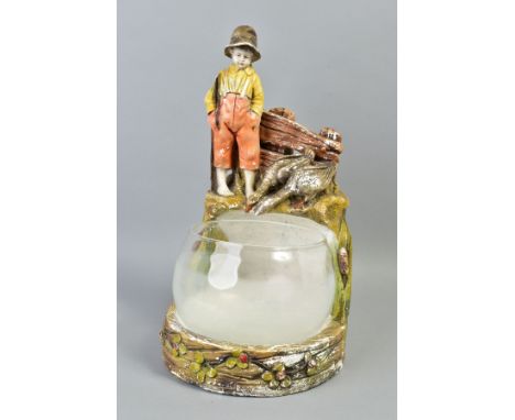 A 1920'S/30'S GLASS FISH BOWL ON FIGURAL PLASTER STAND, modelled as a bare footed young boy with fishing rod and two geese lo