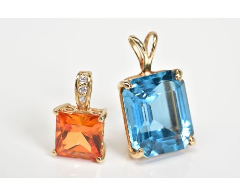 TWO PENDANTS, the first a cushion cut blue stone assessed as topaz within a four claw setting, with a bifurcated suspension h