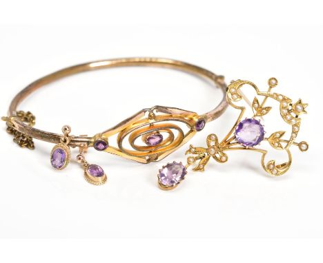 AN AMETHYST COLLECTION OF JEWELLERY to include an early 20th Century amethyst gold plated oval hinged bangle, a gold early 20