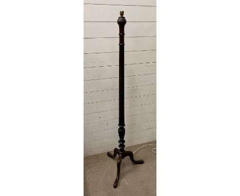 A mahogany stand lamp on tripod legs 