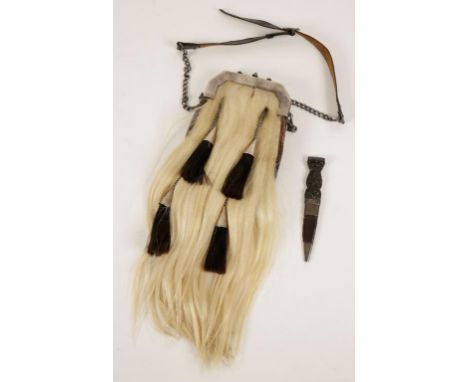 A SILVER MOUNTED SPORRAN with a chain and leather belt, and a sgian-dubh with carved wood handle, 18cm long, 19th century.