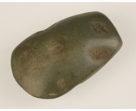 A NEOLITHIC POLISHED GREENISH STONE AXE, rounded oblong form. 90mm, c.219.7g.