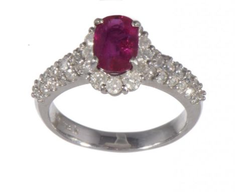 A RUBY AND DIAMOND RING  the larger single oval ruby of approx 5.7 x 8.2mm, in white gold marked K14, 4.8g, size M½ ++In sati