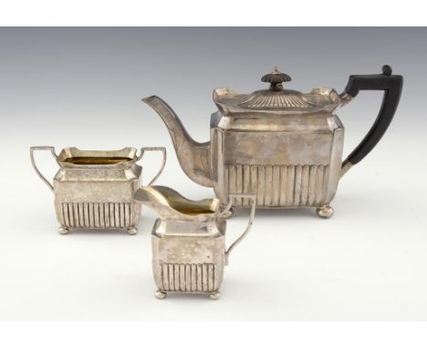 A VICTORIAN SILVER REEDED OBLONG TEA SERVICE on bun feet, teapot 14.5cm h, by The Goldsmiths & Silversmiths Co, London 1899, 