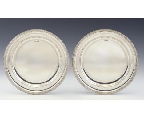 A PAIR OF GEORGE V SILVER DISHES  30cm diam, by Maple & Co Ltd, London 1917, 60ozs10dwts ++Satisfactory condition with light 