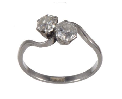 A DIAMOND CROSSOVER RING  with round brilliant cut diamonds, in platinum marked PLAT, 3.2g, size M½ ++In satisfactory second 