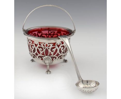 A VICTORIAN PIERCED AND ENGRAVED SUGAR BASKET  with beeded rim and scroll handle, glass liner, 15cm h, by Henry Wilkinson & C