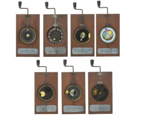 ASTRONOMY.  A SET OF SEVEN BRASS, MAHOGANY AND PAINTED GLASS MECHANICAL MAGIC LANTERN SLIDES BY WATKINS & HILL, LONDON, MID 1