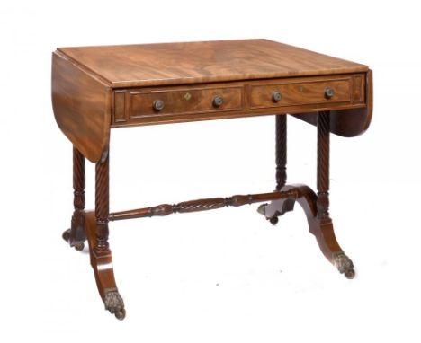 A GEORGE IV MAHOGANY SOFA TABLE  the figured top with drawers and opposing blind drawers, on spirally reeded, coupled standar