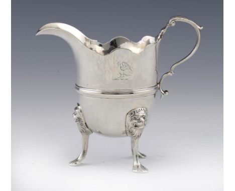 AN IRISH GEORGE II SILVER CREAM JUG  on three lion mask headed legs, crested 12.5cm h, by Andrew Goodwin, Dublin, mid 18th c,