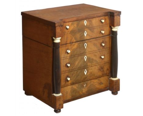 A GERMAN IVORY MOUNTED MAHOGANY DECANTER CASE IN THE FORM OF A CHEST OF DRAWERS, MID 19TH C  with ebonised pillars, the scarl