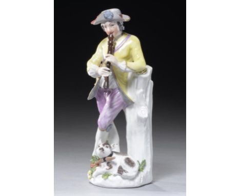 A MEISSEN FIGURE OF AN ITINERANT MUSICIAN, C1760  resting beside a tree stump and playing the recorder, a dog at his feet, 17