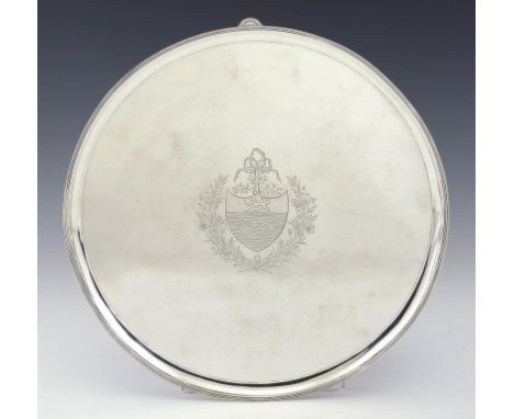 A GEORGE III SILVER SALVER with reeded rim and feet, engraved with armorials, 36cm diam, by William Stephenson, London 1790, 