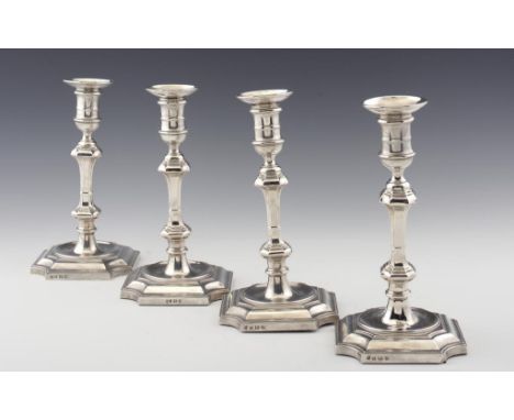 A SET OF FOUR GEORGE V SILVER CANDLESTICKS with nozzles, 26cm h, by Hawksworth, Eyre & Co Ltd, Birmingham 1932 & 34, loaded +