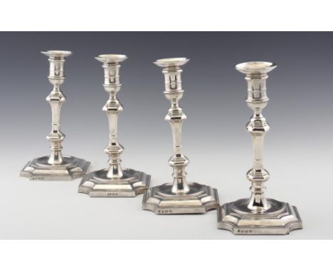 A SET OF FOUR GEORGE V SILVER CANDLESTICKS with nozzles, 26cm h, by Hawksworth, Eyre & Co Ltd, Birmingham 1932 & 34, loaded +