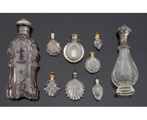 A SILVER MOUNTED BOHEMIAN RUBY FLASHED GLASS SCENT BOTTLE AND EIGHT OTHER, MAINLY MINIATURE, BOTTLES WITH SILVER OR GILTMETAL