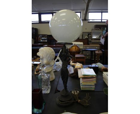 Figural table lamp with globe shade