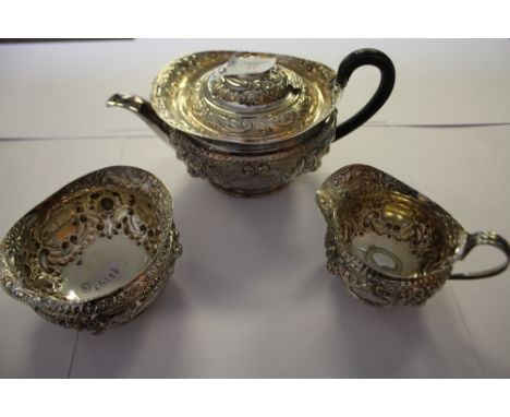 Late Victorian embossed silver three piece tea service by Henry Atkin, Sheffield 1897, gross weight 18ozs (pot lacking finial