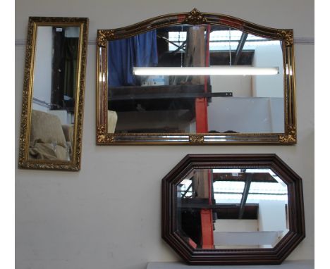 A large gilt wall mirror together with a smaller gilt wall mirror and a walnut framed wall mirror