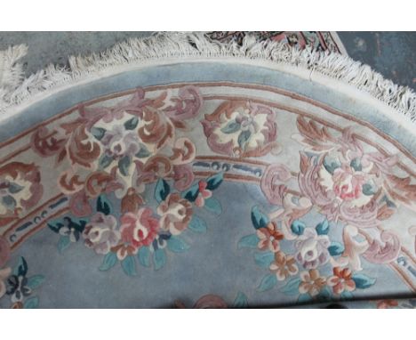 A light blue ground circular Chinese rug and two smaller Chinese rugs