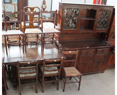 A 20th century oak extending dining table, dresser and four ladder back dining chairs, together with four bedroom chairs