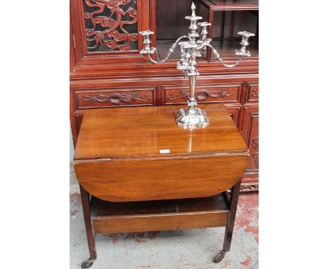 A 20th century mahogany tea trolley together with an electroplated four branch candelabra