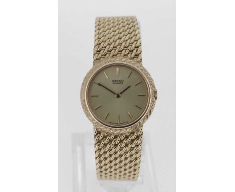 quartz movement, having integrated textured 18KT gold bracelet, the back engraved with numbers ‘980013’ and ‘14-0329-D’, 16cm