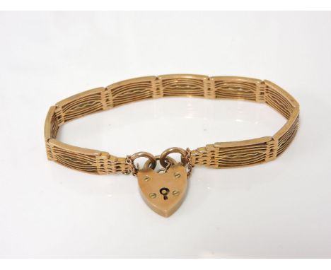 An Edwardian gold fancy nine row panel link gate bracelet, with padlock, marked 9ct, 18.24g