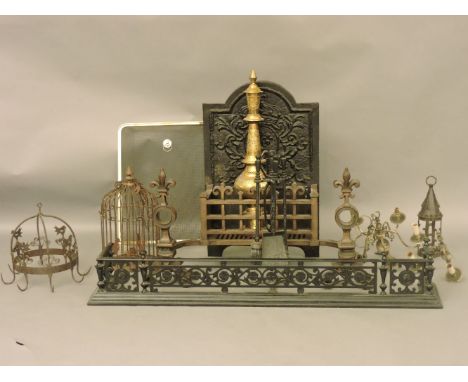 A large iron fire basket, with fleurs-de-lys integral doors, and a cast iron back, 87cm x 46cm, together with an iron fender,