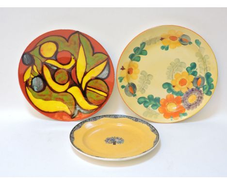 A Poole Delphis pottery charger, with stylised motifs, on a red ground, 35cm diameter, a Royal Worcester charger, 30.5cm and 