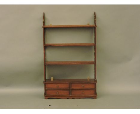 A reproduction four tier Victorian style wall shelf, with four short drawers, 70cm wide, 113cm high