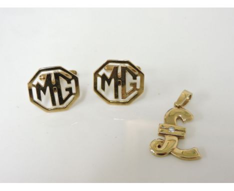 A pair of 9ct gold MG emblem cufflinks, and a single stone diamond pound sign pendant