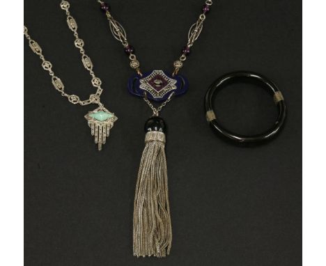 An Art Deco costume jewellery silver-plated pendant,with a centrepiece set with French cut purple paste to a tassel drop, rep