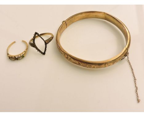 A gold hinged bangle, marked 9ct, a vacant ring mount, marked 18ct, and a boat shaped broken ring mount, two diamonds remaini