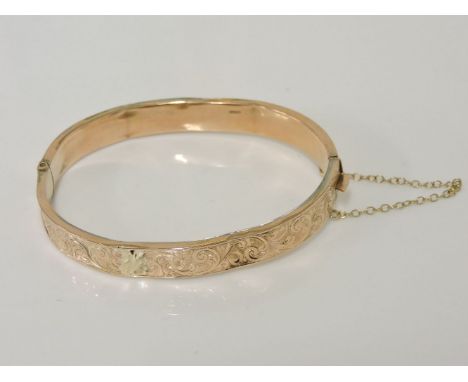A 9ct gold hollow hinge bangle, with engraved decoration, extensive damage, 9.77g