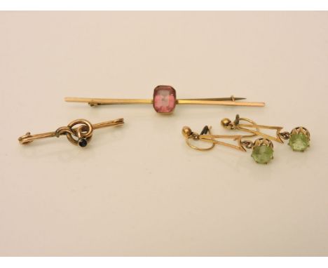 A gold enamel cut pink tourmaline bar brooch, marked 9ct, a pair of gold pendant drop earrings, and gold knot brooch set with