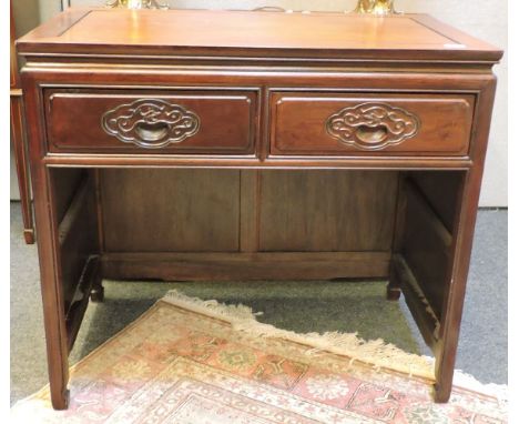 An oriental hardwood dressing table, the two frieze drawers carved with dragons, together with a matching dressing stool and 