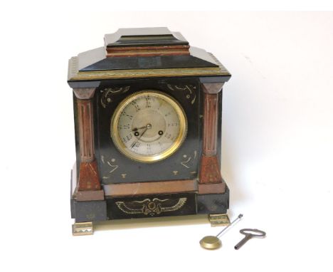 A victorian black slate and metal mounted mantel clock, in the Egyptian taste,27cm wide