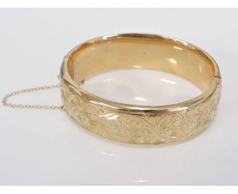 A 9ct gold hinged bangle, with hand engraved top section, 24.39g