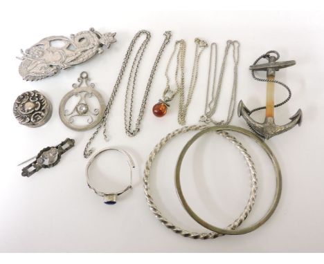 A Victorian silver anchor with faceted agate column, a silver bangle, a silver triton brooch, an amber pendant on chain, a si