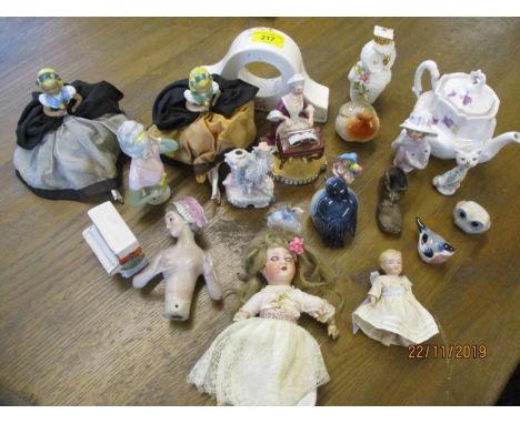 A collection of ceramic dolls and powder puff ladies torsos 