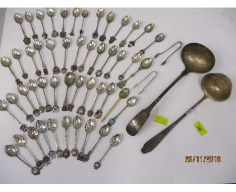 A white metal ladle and another, together with collectors teaspoons and sugar tongs 