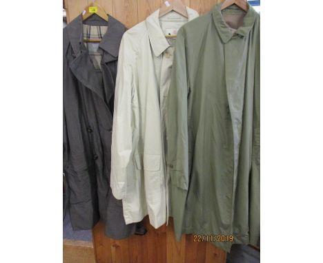 A vintage Aquascutum Aqua 5 gents steel grey rain mac, together with a cream Aquascutum rain mac and a green Aquascutum Aqua 