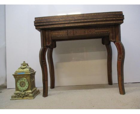 A 20th century West Asian mix veneered games table, with a rotating fold-over top, enclosing a hinged velvet surface, relievi